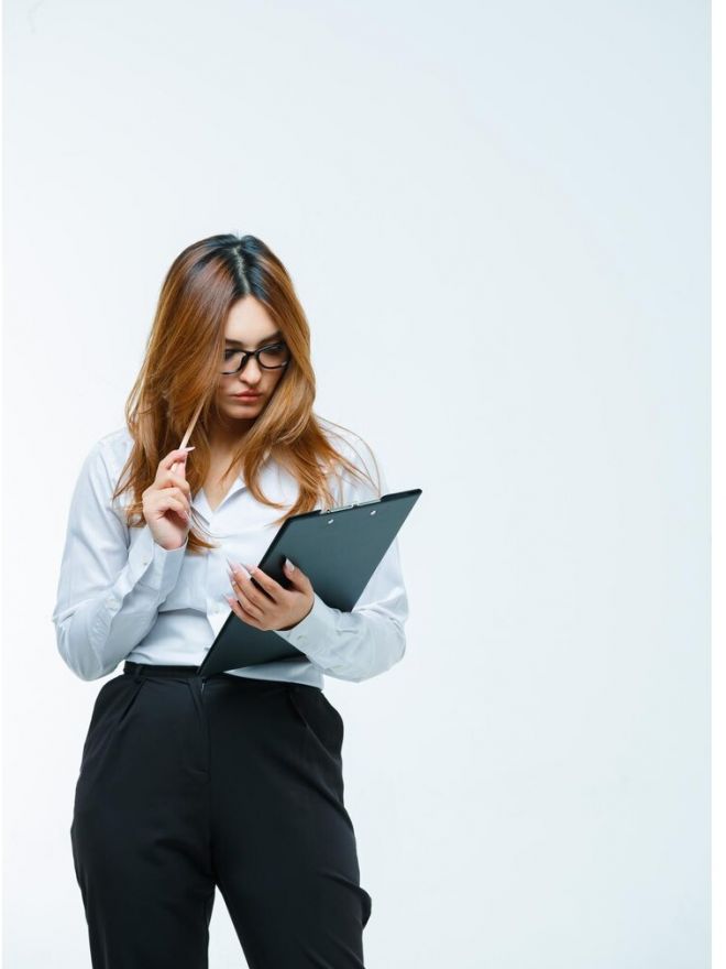 young-woman-looking-through-clipboard_176474-95428.jpg